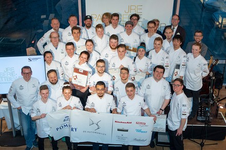 Eine Vielzahl von Patissiers mit Urkunden in der Hand