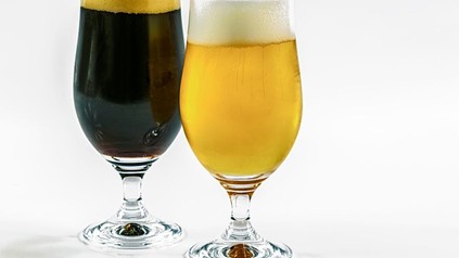 Zwei volle Biergläser, eines mit hellem, eines mit dunklem Bier