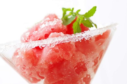 Ein Sektglas mit Erdbeersorbet und einem Minzblatt