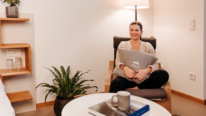 Katharina Schreiner sitzt in ihrer neuen Wohnung und strahlt über das ganze Gesicht.