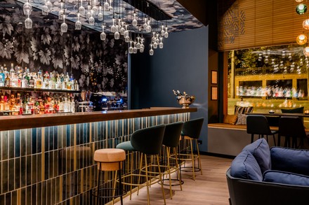 Im Motel One in Wiesbaden hängen Weingläser als Leuchten von der Decke. (Foto: © Motel One)