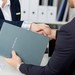 Zwei Menschen schütteln sich beim Bewerbungsgespräch die Hände