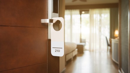 The hotel room with Room Number sign on the door