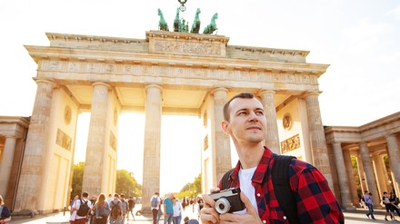 Tourist mit Kamera vor dem Brandenburger Tor
