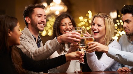 Group Of Friends Enjoying Evening Drinks In Bar