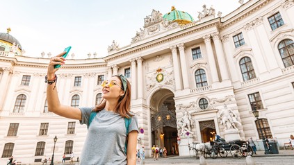 Asiatische Touristin vor der Wiener Hofburg