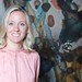 Porträt von Anna Heuer in rosafarbener Bluse vor einer farbig gestalteten Wand