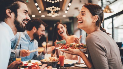 Group of Happy friends having breakfast in the restaurant