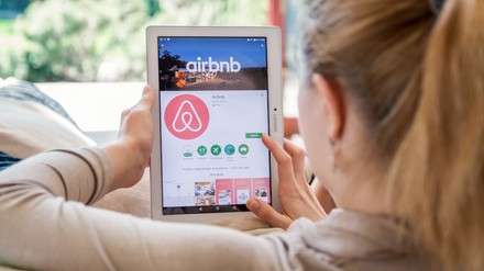 WROCLAW, POLAND- APRIL 10th, 2017: Woman is installing Airbnb application on Lenovo tablet. Airbnb is an online marketplace and hospitality service, enabling people to lease or rent short-term lodging
