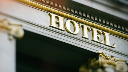 Hotel word with golden letters sun flare