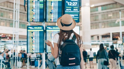 tourist at the airport looks at the scoreboard