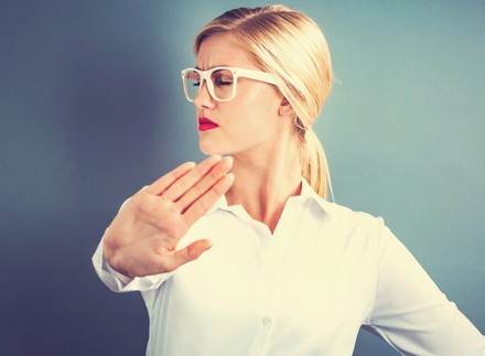 Frau streckt Hand von sich und sieht empört aus