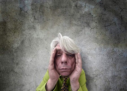 Mann hält sich die Hände an den Kopf