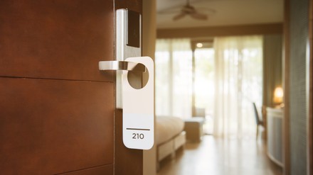 The hotel room with Room Number sign on the door