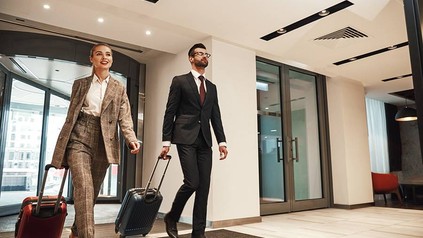 2 Geschäftsreisende verlassen das Hotel