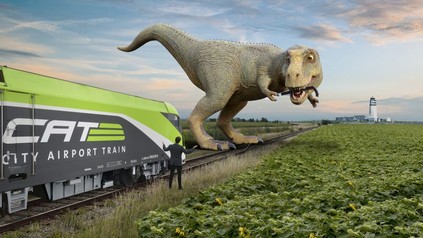 Ein Dinosaurier steht auf einem Bahngleis, zerstört die Weichen und hält den Zug auf