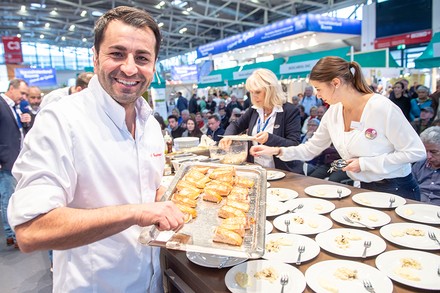 Spitzenkoch Ali Güngörmüs an einem Messestand
