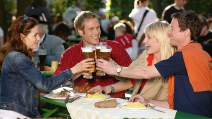 FReunde im Biergarten stoßen an