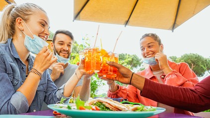 Gruppe von Menschen stößt mit Cocktail an