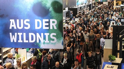 Eine große Messehalle mit vielen besuchern